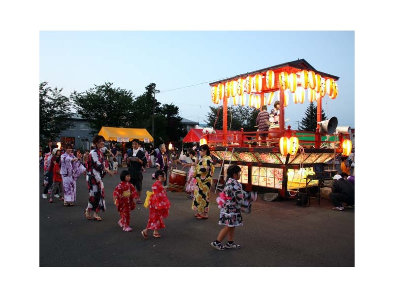 盆踊りを踊る浴衣で着飾った子どもたち