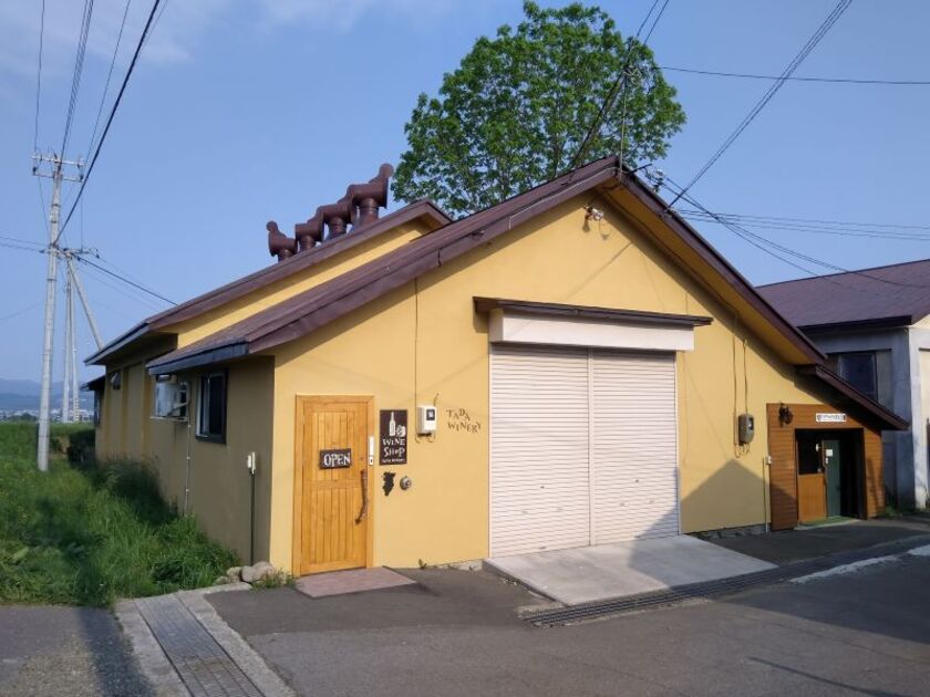 ワインレッドの屋根の建物が目印